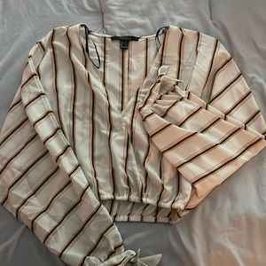Cropped white top with black, gold, and pink thin stripes